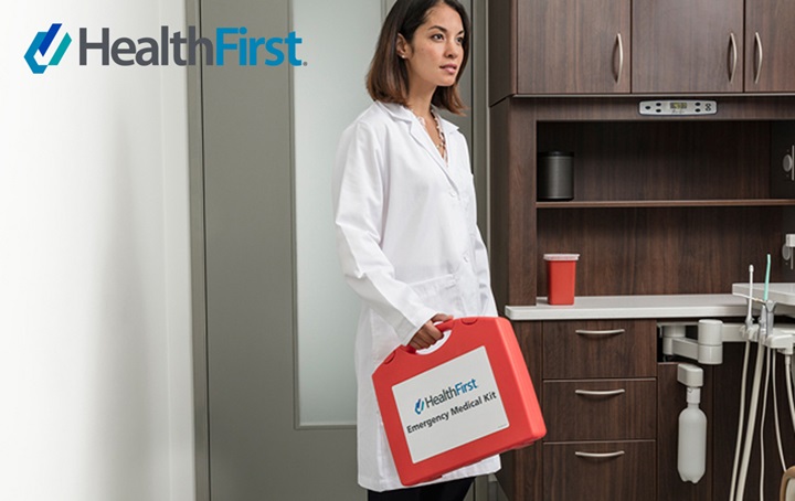 HealthFirst — Woman carrying emergency medical kit