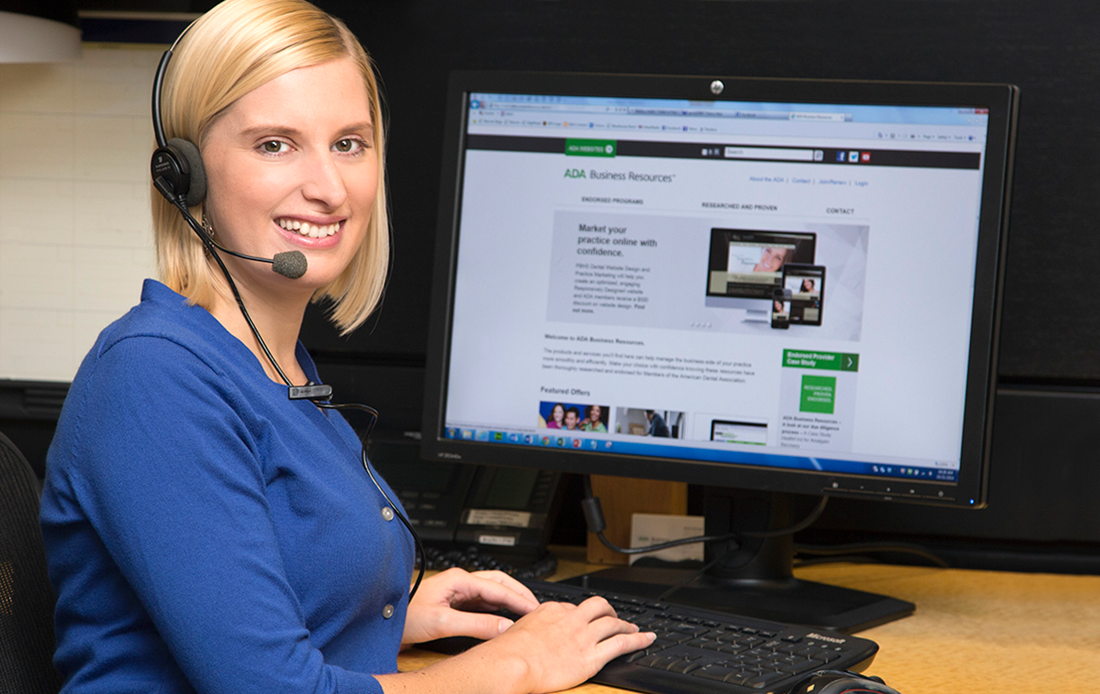 A photograph of Andrea, in front of her computer, with a head set on, ready to assist you with all your ADA Member Advantage questions.